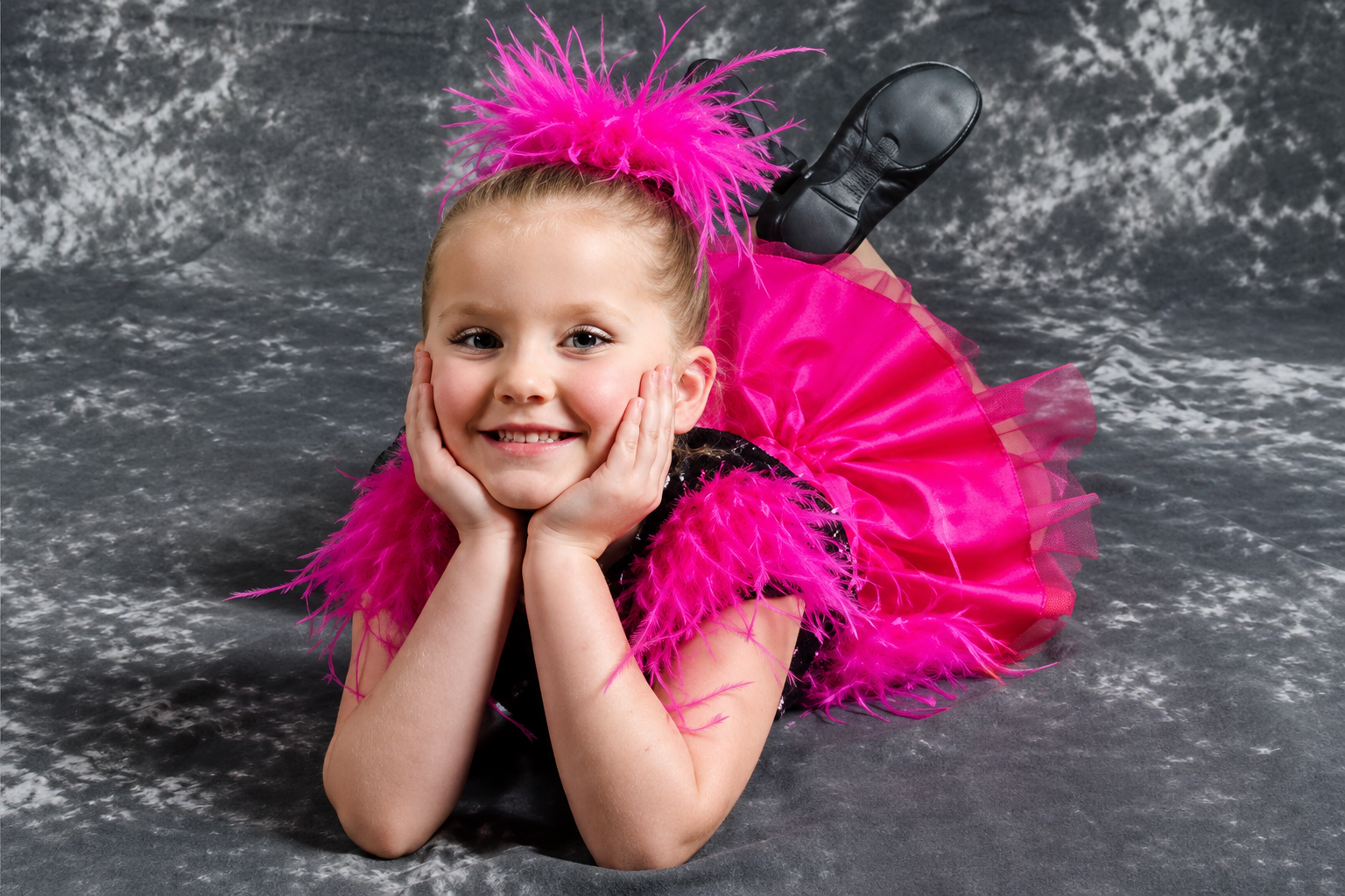 Oxbow Dance student smiling in a pink feathered costume