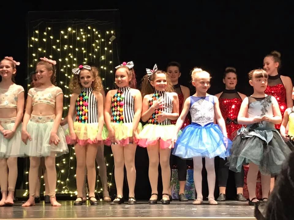 Oxbow Dance students on stage in costume at the year-end recital