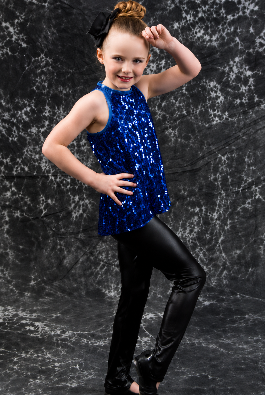 Oxbow Dance tap student in a blue sequined costume posing